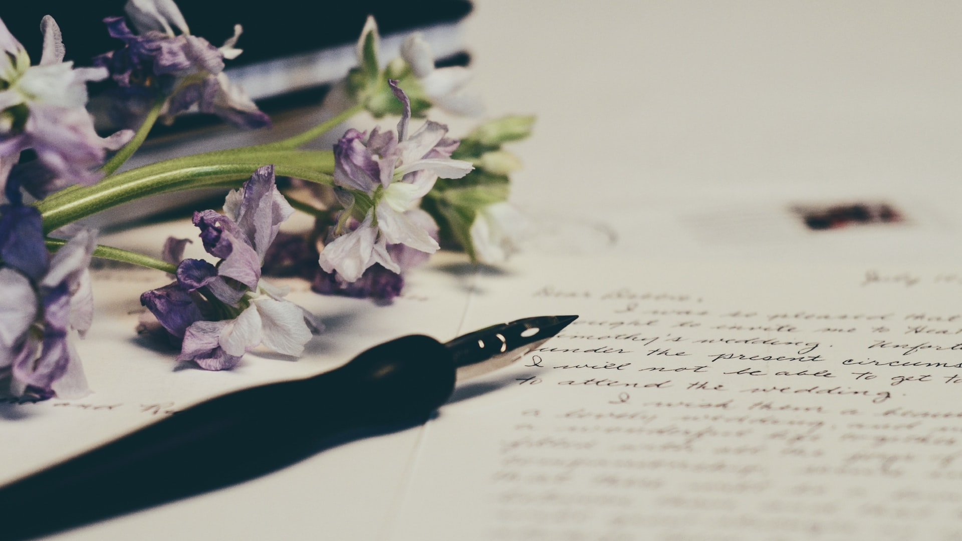 pen and paper with purple flowers